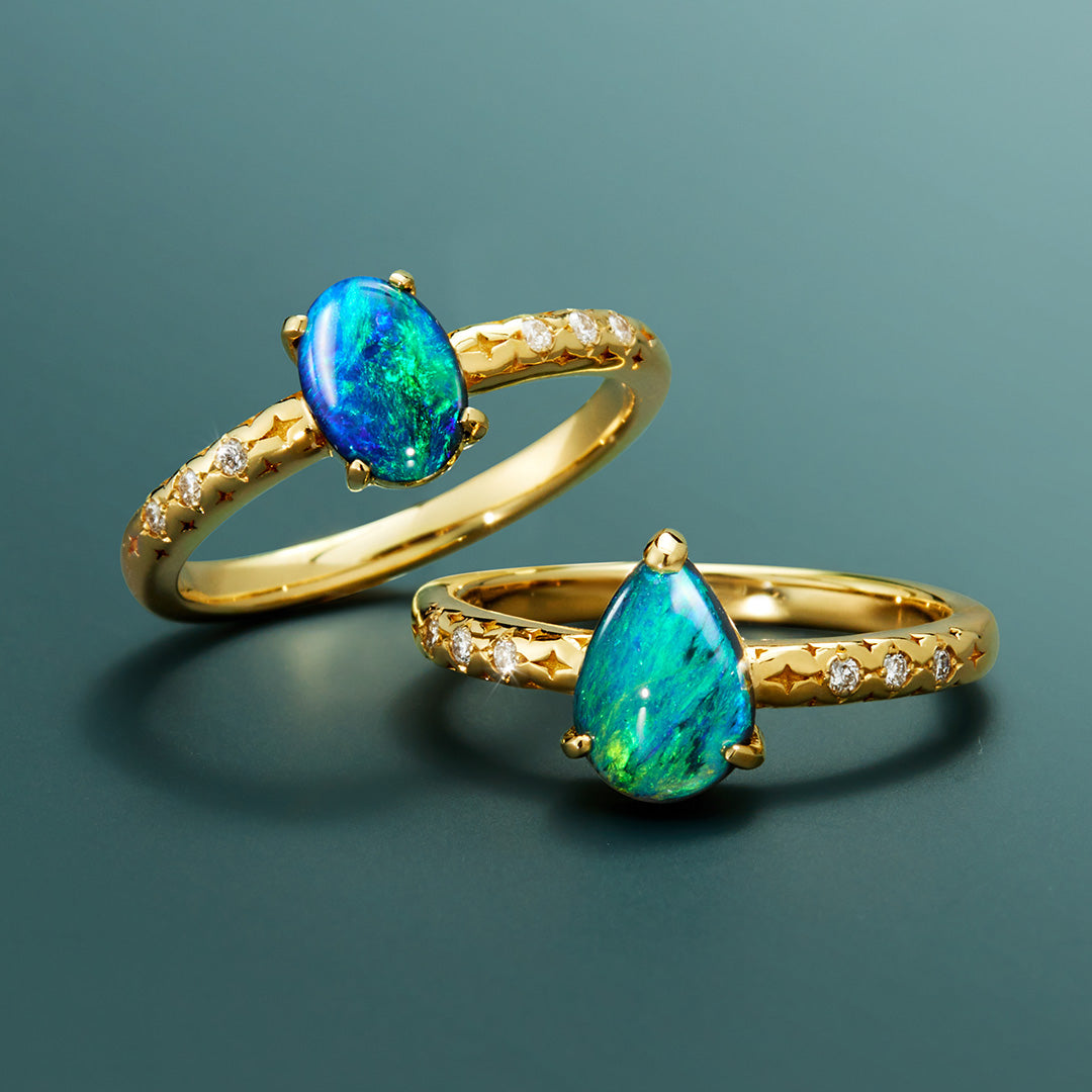 Two gold rings with blue-green gemstones.